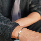 PULSERA CRUZ HILO GRIS HOMBRE PLATA