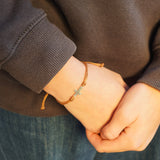 PULSERA CRUZ HILO CAFÉ NIÑO PLATA