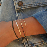 PULSERA ESCLAVA DELGADA TORCIDA ENCHAPE ORO