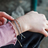 PACK PULSERAS VIRGEN MINI GRIS Y TELAR MORADO VERDE