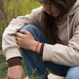 PULSERA TELAR DELGADA ROJA 3 BOLITAS PLATA TEEN
